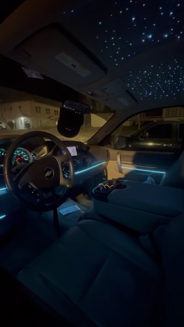 Starlight headliner and ambient lighting inside a Chevy truck at night